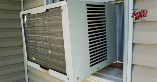 A window air conditioning unit installed in a residential home.