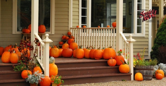 A house decorated with pumpkins for fall.