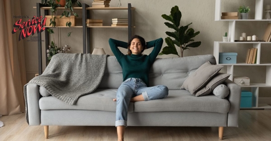 Woman sitting on couch.