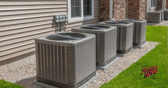 Heat pumps outside of a residential home.