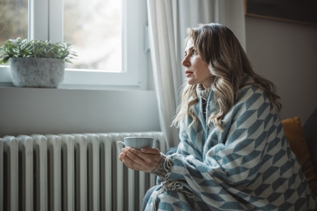 woman feeling cold at home